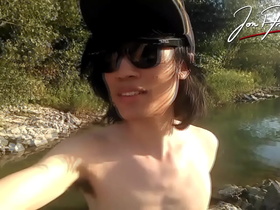 Jon Arteen is this slim Asian twink boy dancing a musical strip-tease on the river smiling showing his full pubes doing outdoor gay porn with a sneaker and underwear fetish